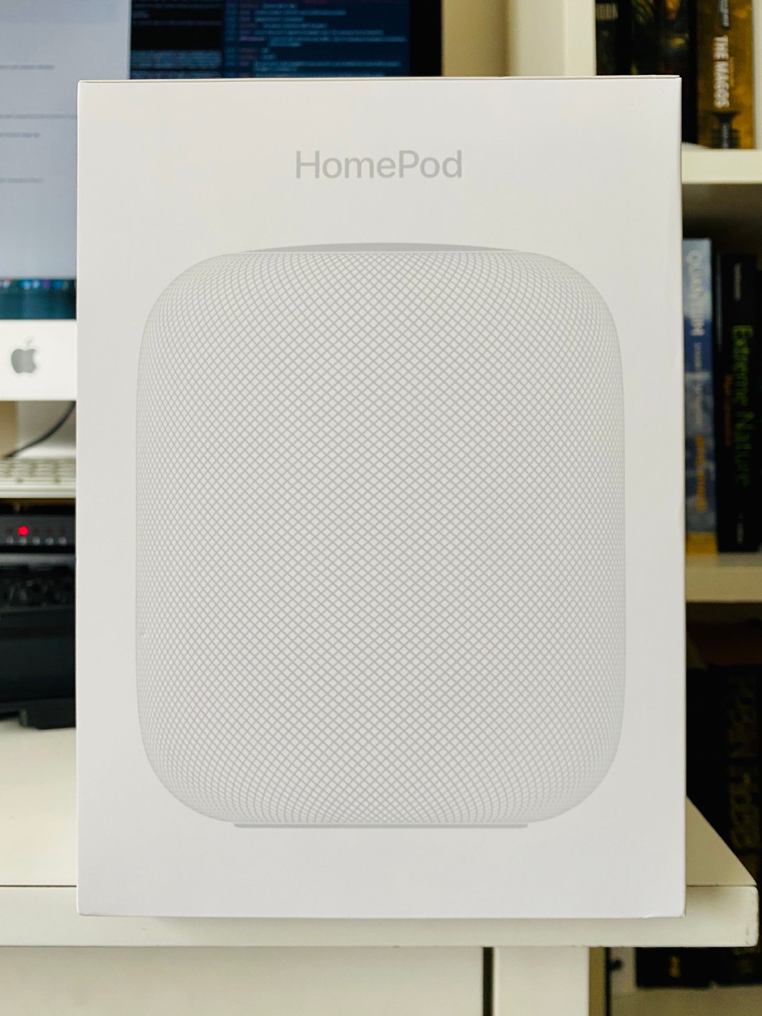 A photo of the box of a white Apple HomePod.