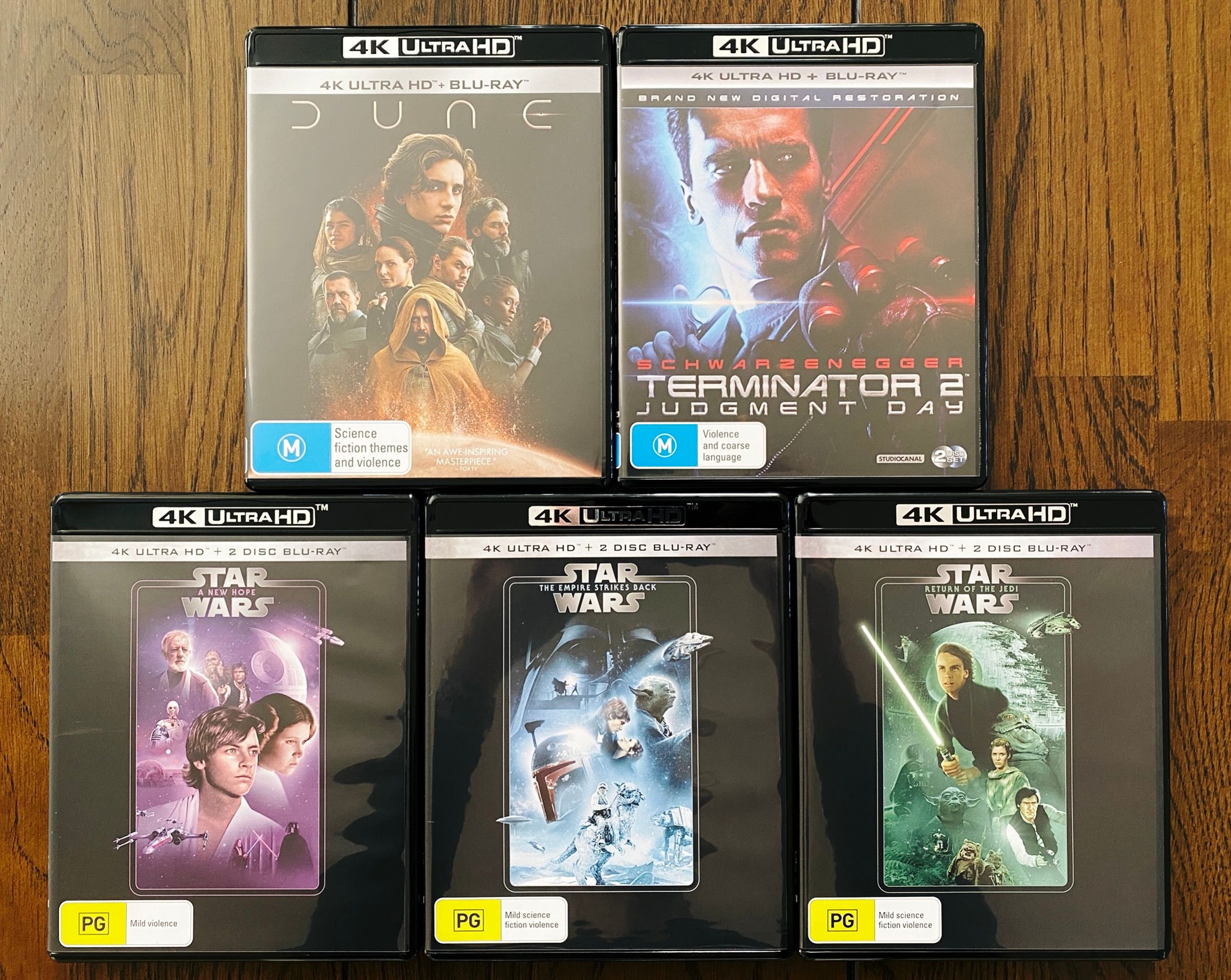 A photo of five 4K HDR Blu-Ray jewel cases: the original Star Wars trilogy, the new 2021 Dune movie, and Terminator 2.