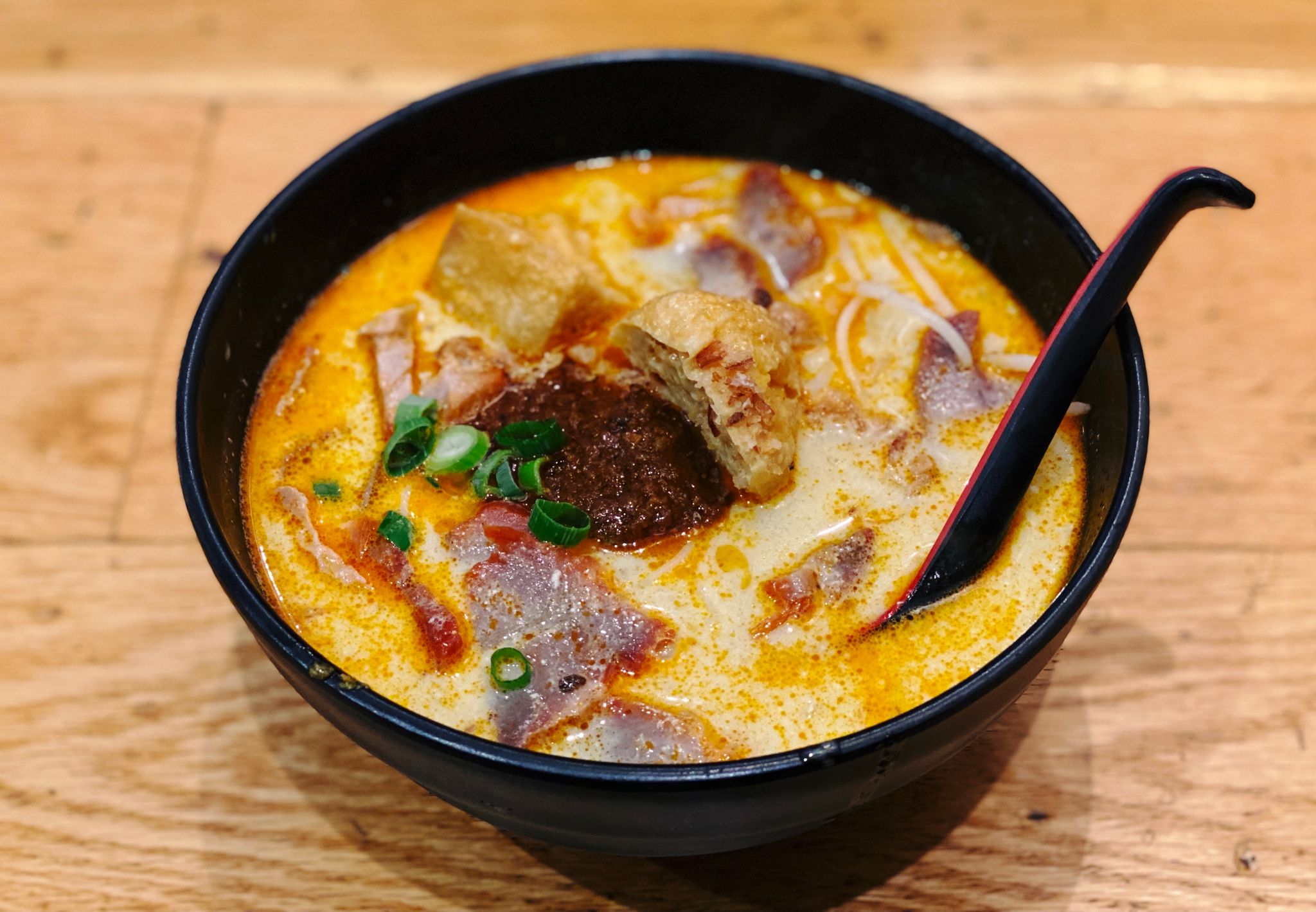 A photo of a bowl of barbecue pork laksa.
