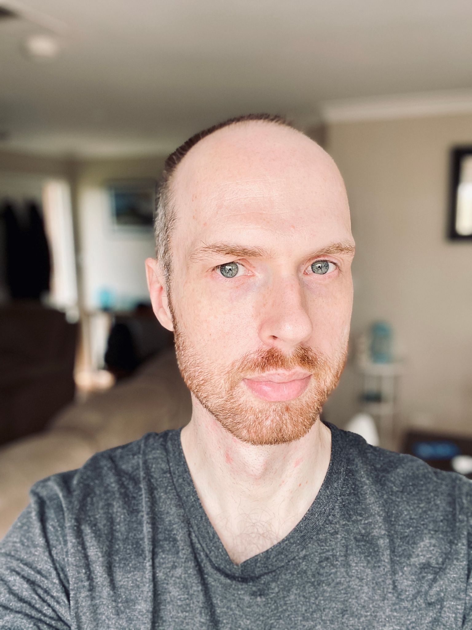 A photo of me, a white man with a short and neat and tidy red beard and a closely shaved head.