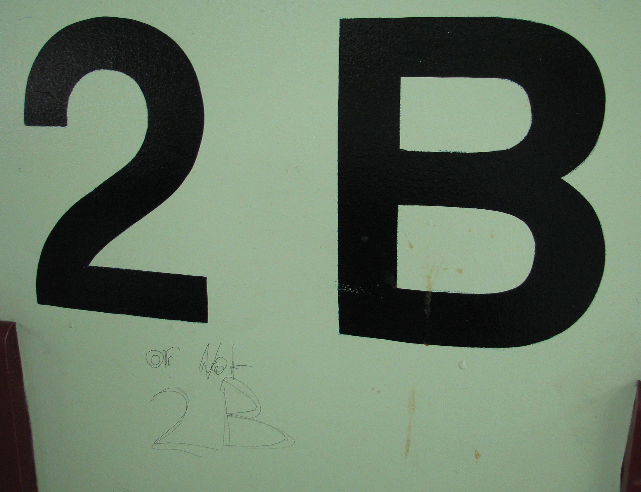 A photo of column in carpark showing the location as being "2B", and someone has scrawled underneath it "or not 2B".
