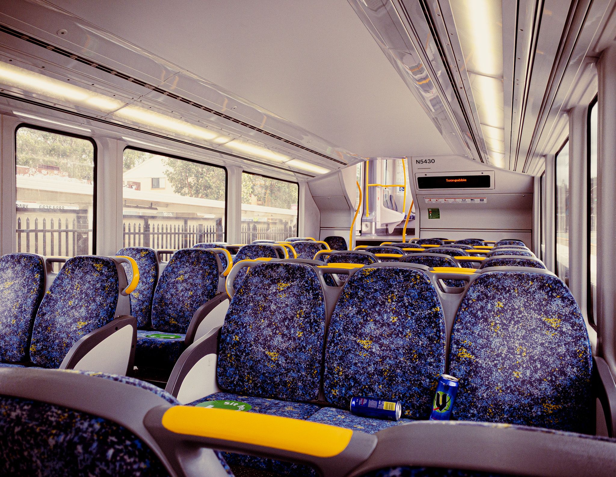 A photo of the inside of a Sydney Trains carriage with absolutely nobody in it.