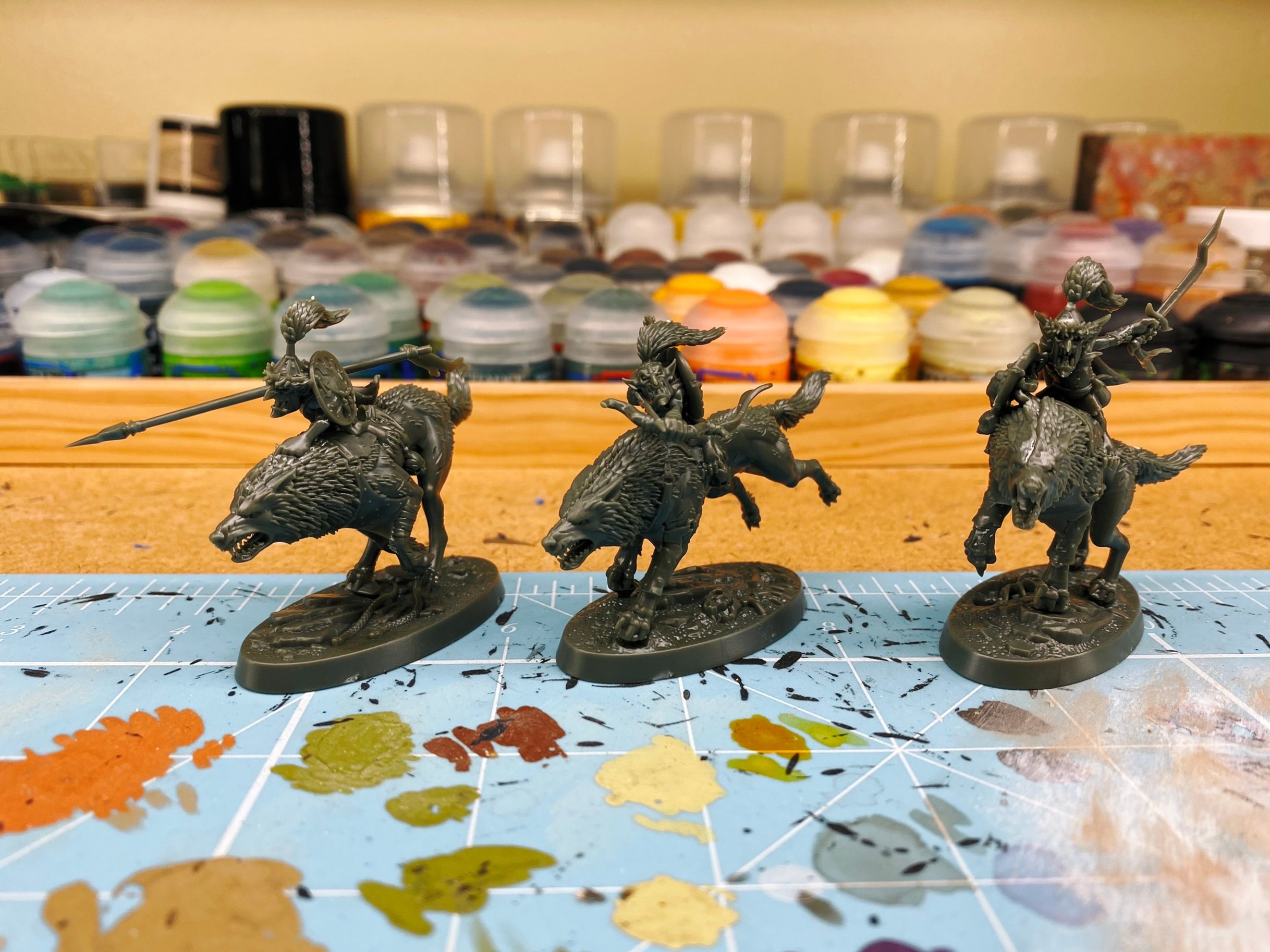 A photo of the Warhammer Underworlds warband "Rippa's Snarlfangs". It consists of three goblins with Mongolian-style hats riding on the back of big wolves. One has a big spear, another is aiming a bow and arrow, and the third is waving a sword around.