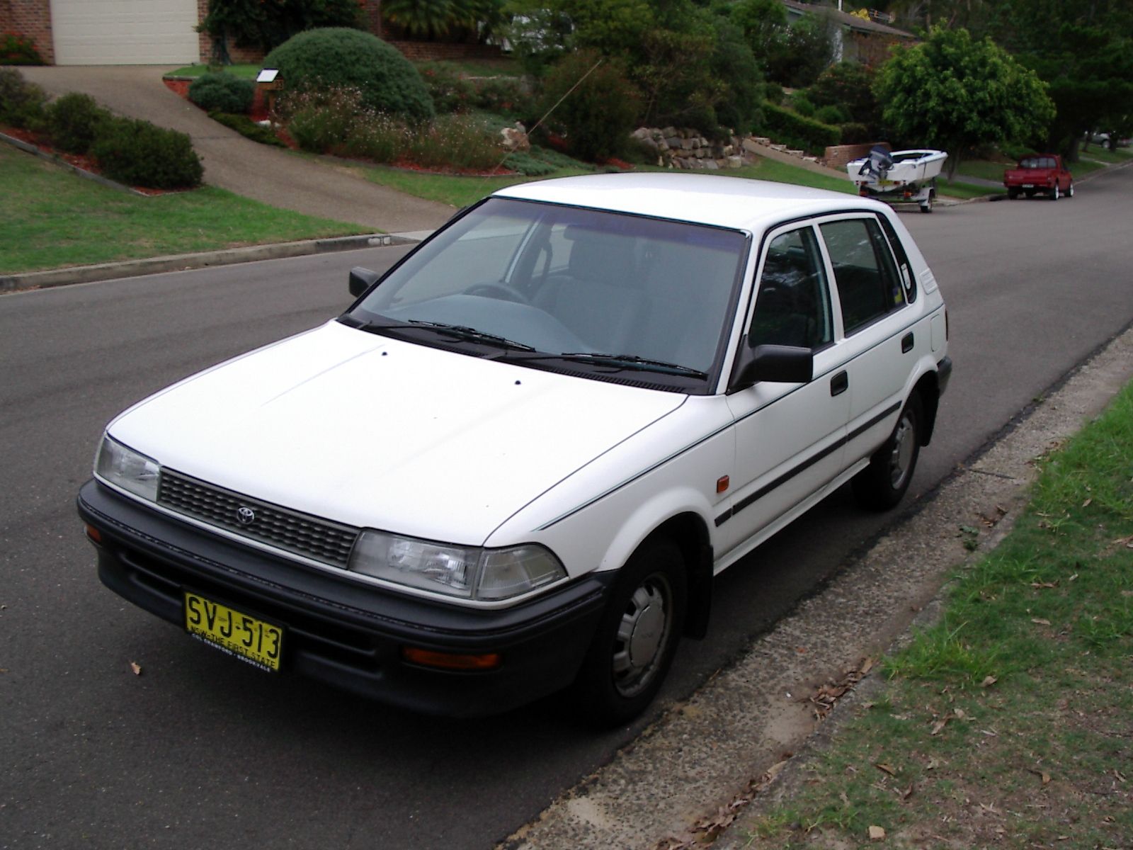 A photo of a white 1993 Toyota Corolla hatchback taken from the front three-quarters.