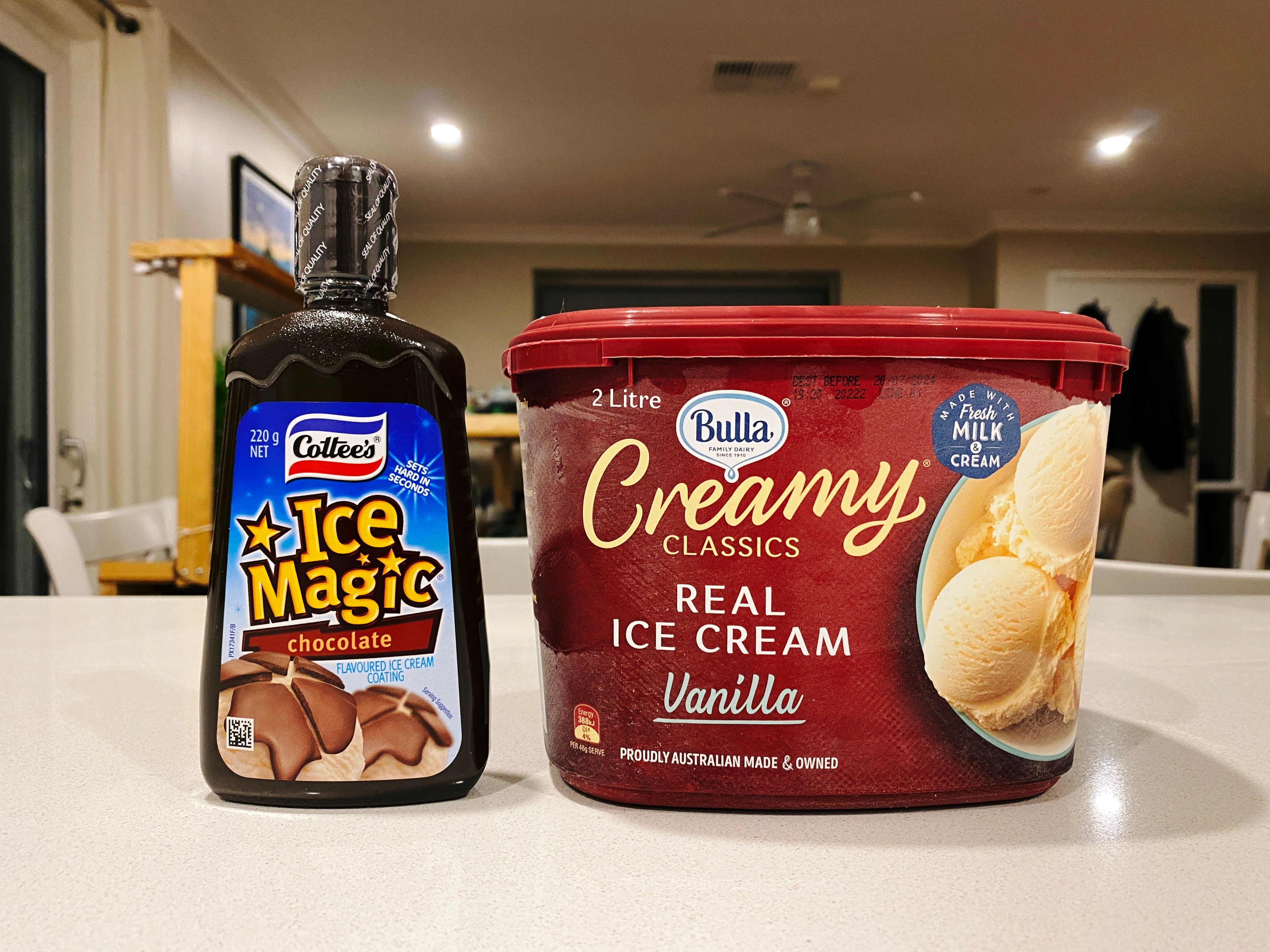 A photo of a two litre tub of Bulla vanilla ice cream and a bottle of Ice Magic chocolate ice cream topping (which Wikipedia helpfully informs me is called "Bird's Ice Magic" in the UK and "Magic Shell" in the US).