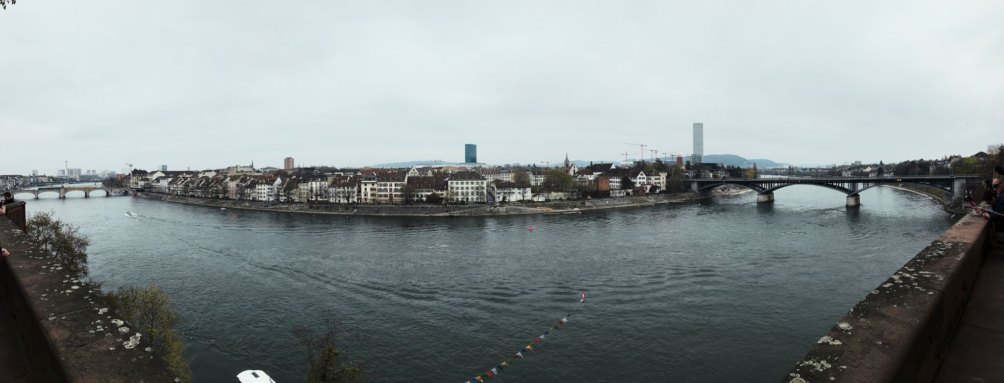 A panorama of the river Rhine, looking across to old buildings.