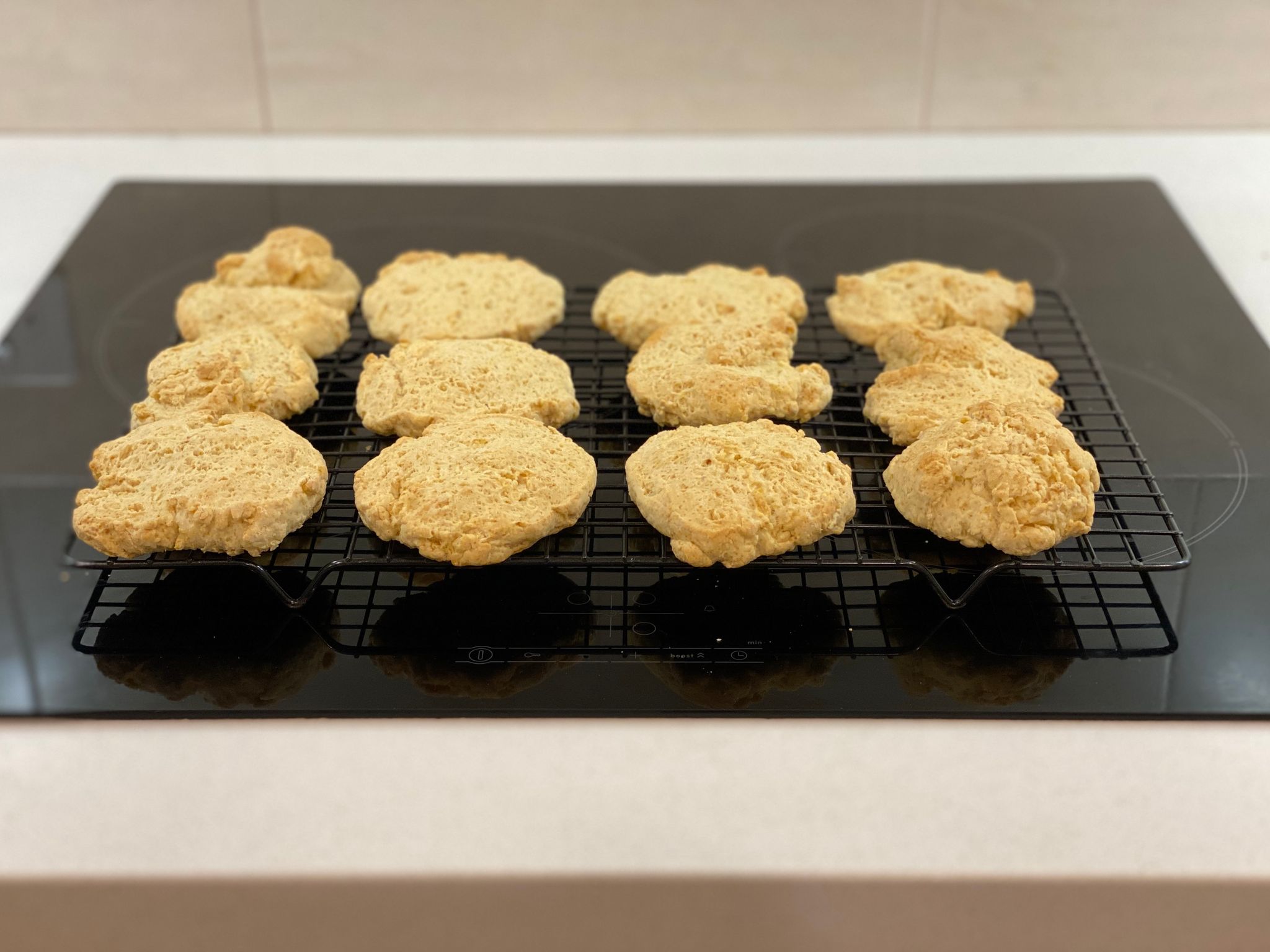 A photo of cut rounds sitting on a cooling rack. They're basically like scones except mine are flat and haven't risen at all.