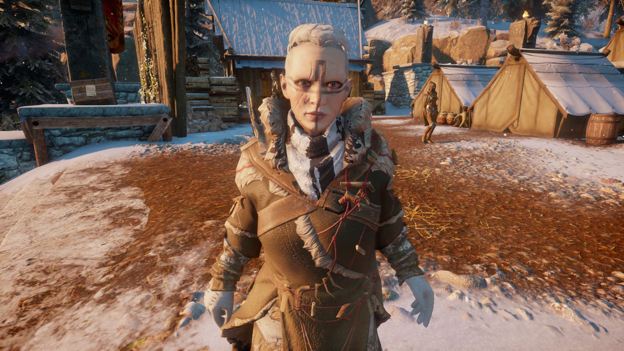 A screenshot from Dragon Age: Inquisition showing a very pale female dwarf with several facial scars and an angular geometric cross-type tattoo going from one temple to the other and from the middle of the forehead down to her chin. The sides of her head are shaved and she's got a mop of white hair on top. She's wearing leathers with animal teeth festooned across it.