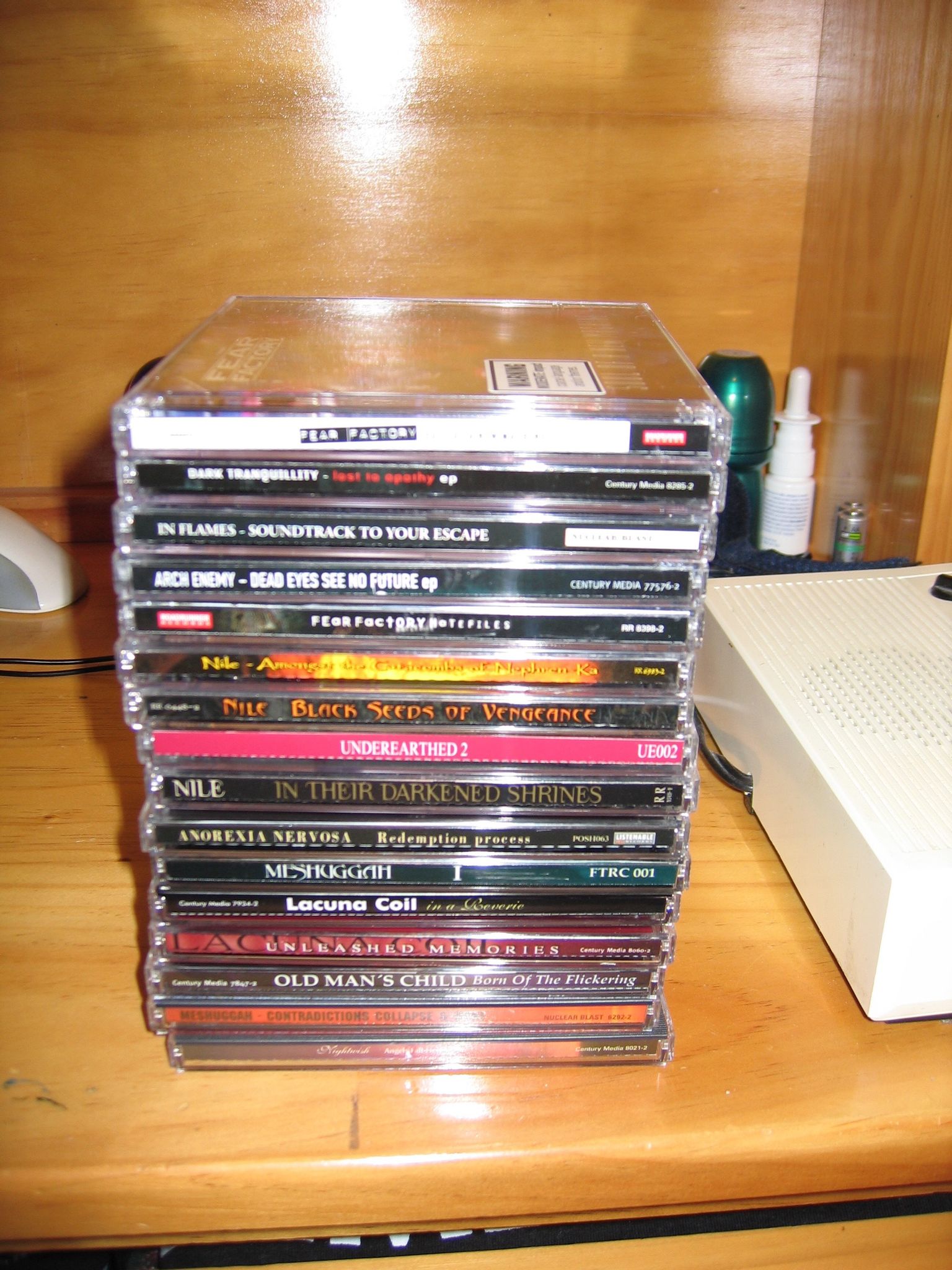 A photo of sixteen CD jewel cases sitting on top of each other, all of it metal of some sort.