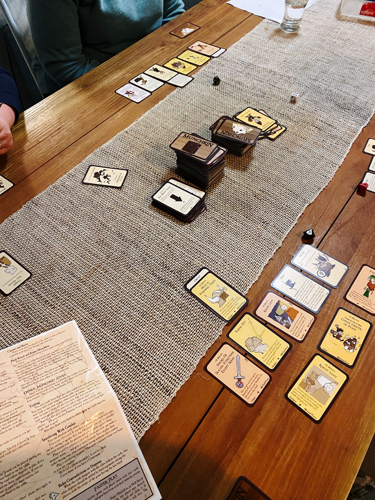 A photo of the card game Munchkin in progress on a table.