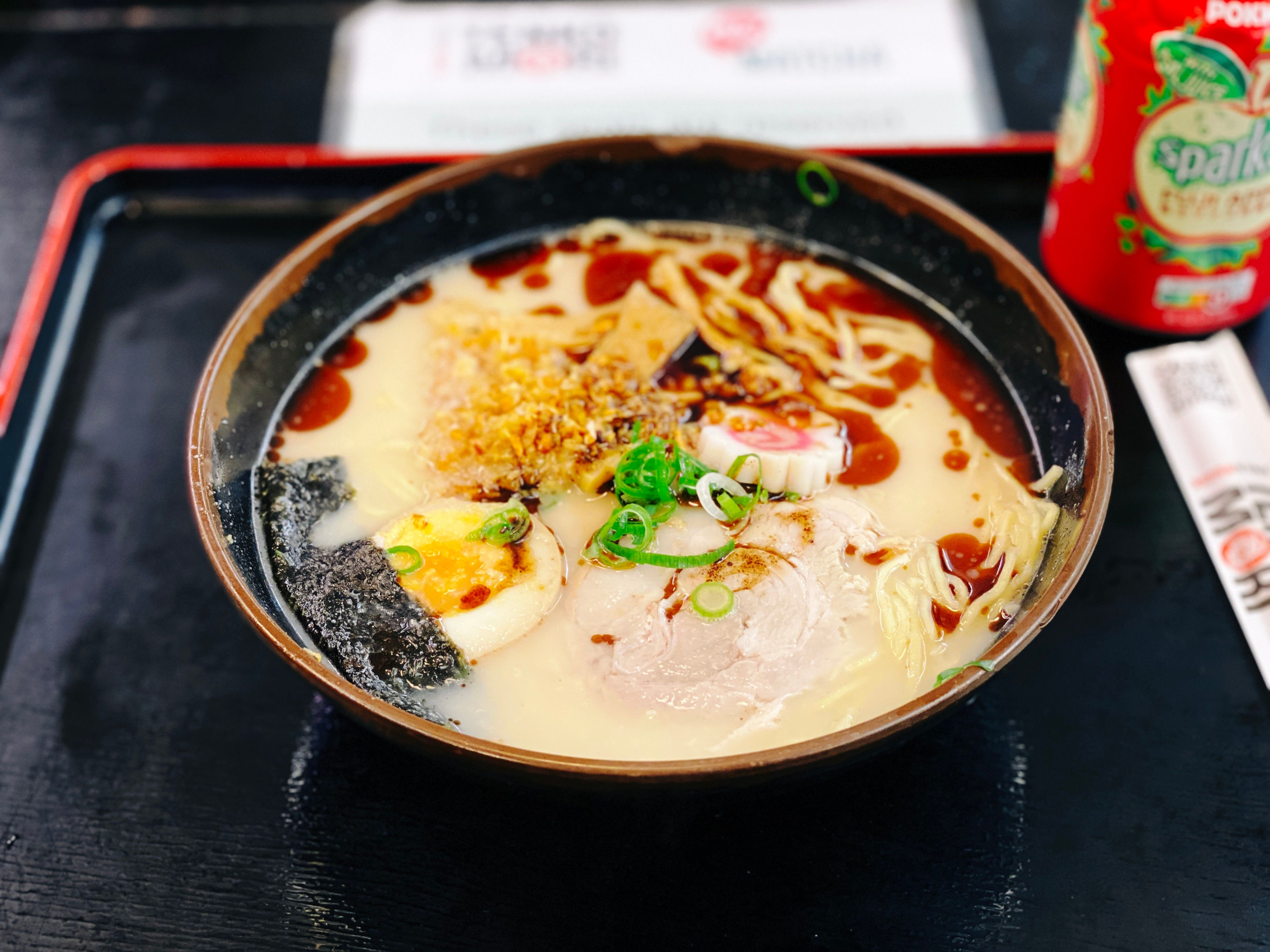 A photo of a big bowl of ramen, with a bunch of garlic on top.