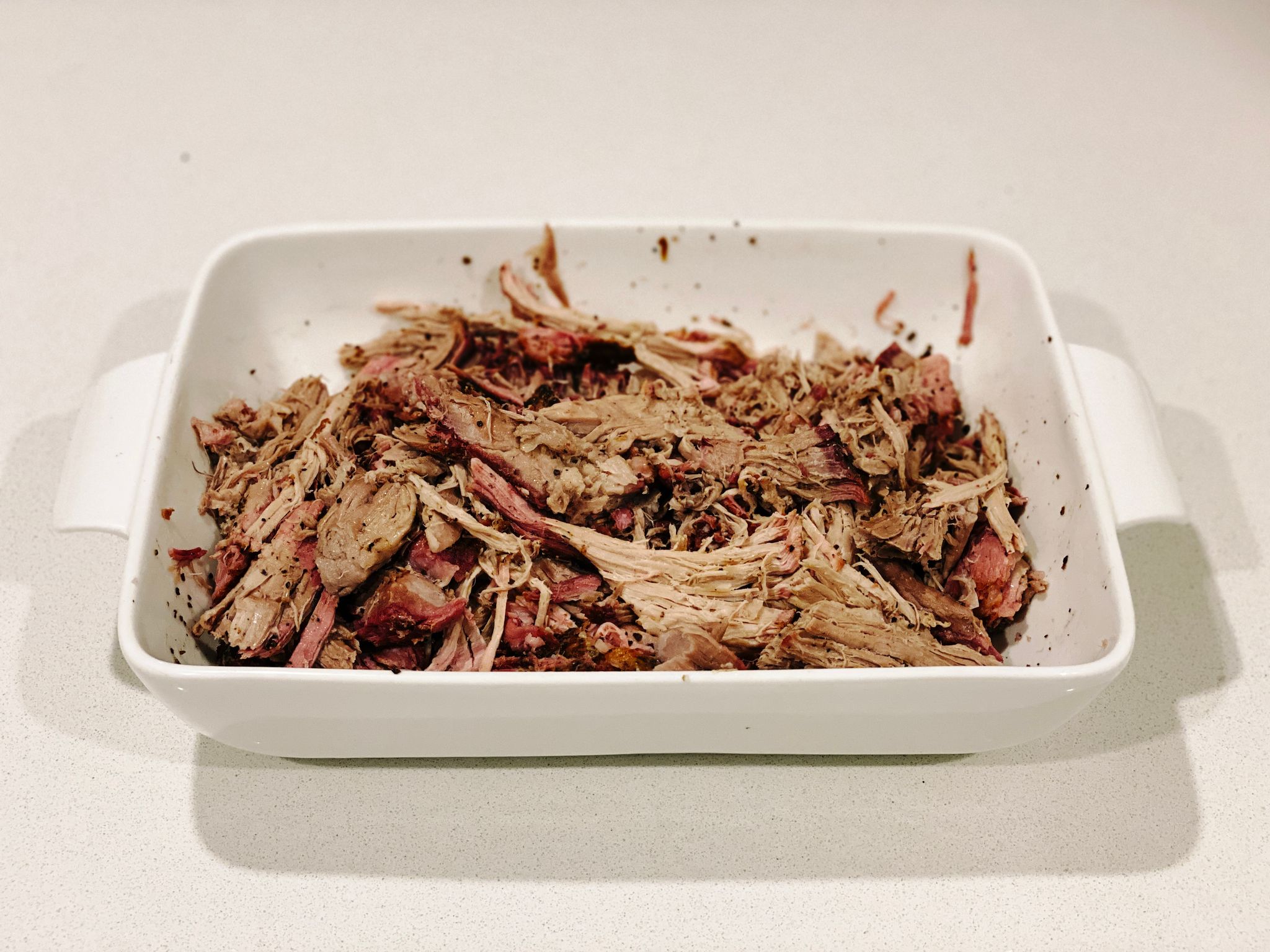 A photo of the pork all shredded up, showing excellent pink smoke ring.