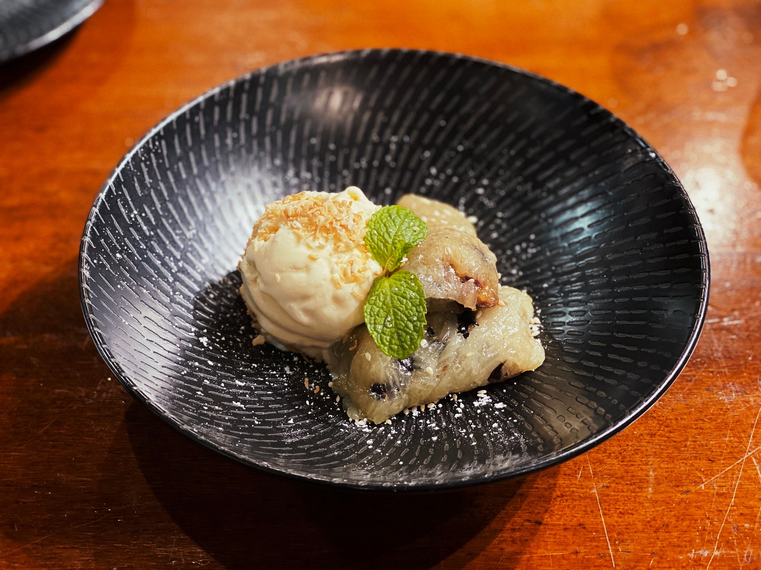A photo of dessert which was billed as "banana with sticky rice and ice cream". The banana seemed like it'd been smushed and shaped around a core of bean paste. Not very appetising-looking but was really tasty.