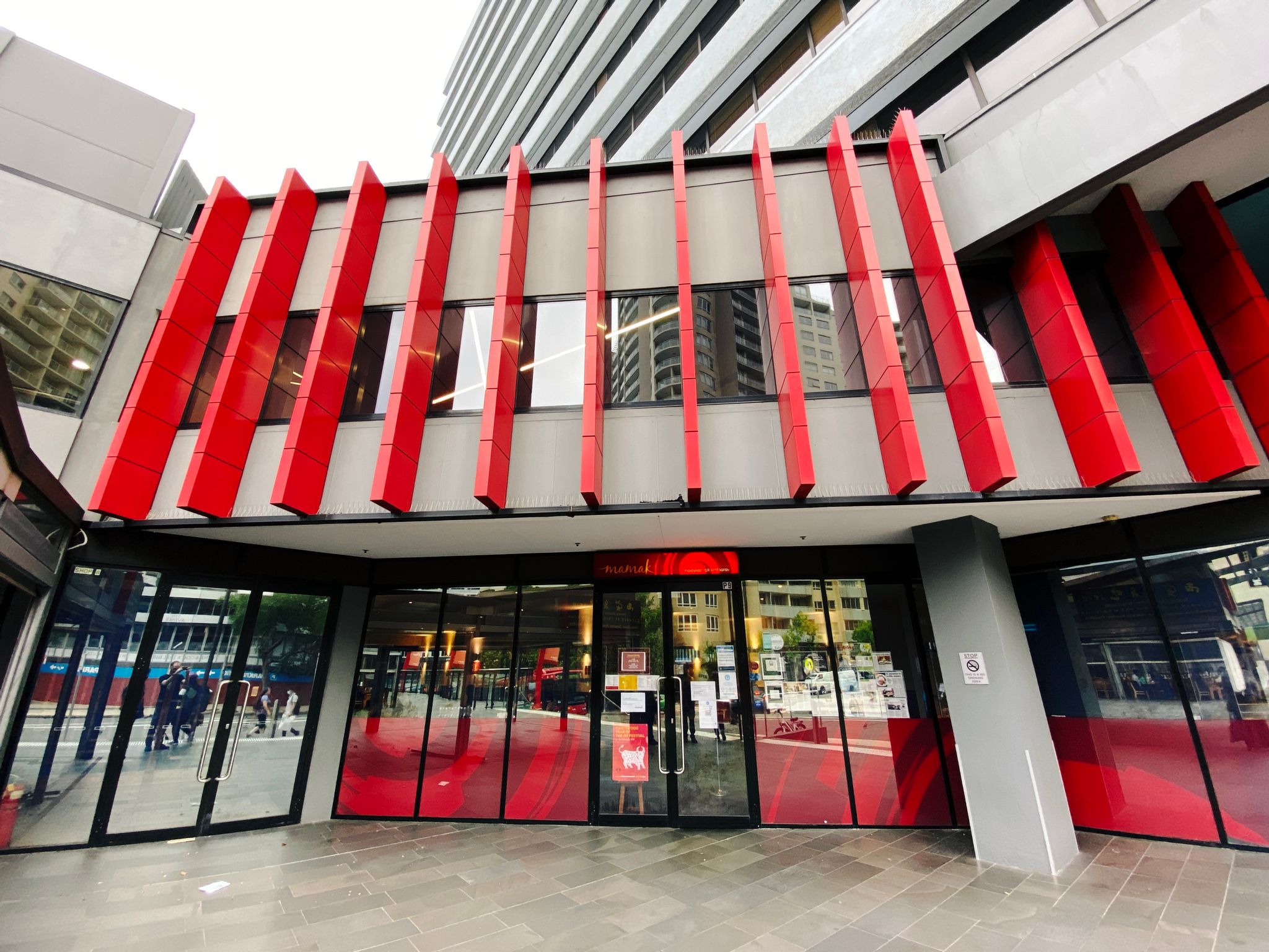 A photo of the outside of the Malaysian restaurant Mamak, in Chatswood. There's lots of red being used in the design.