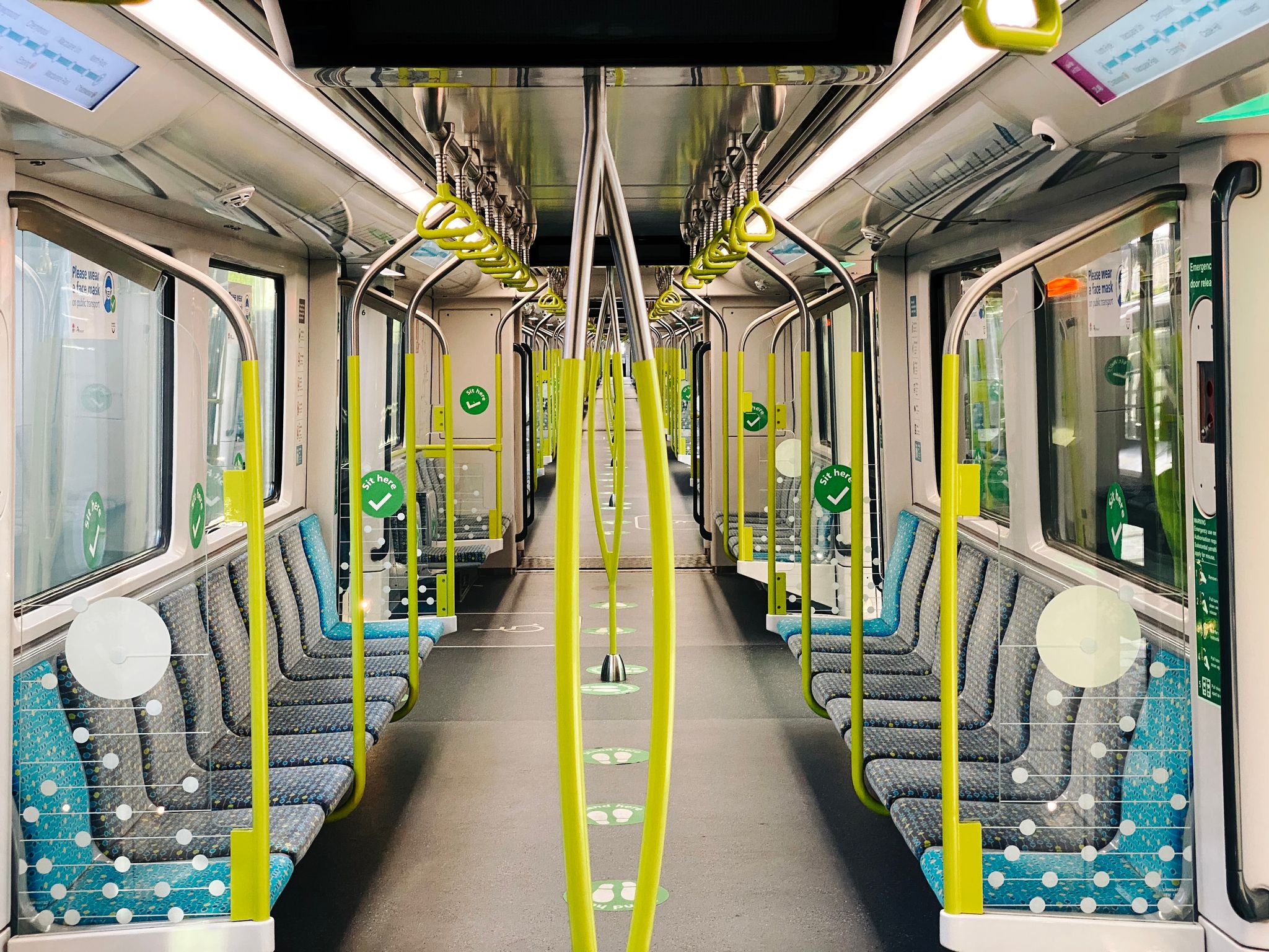 A photo looking down the full length of a Sydney Metro train, with nobody whatsoever on it.