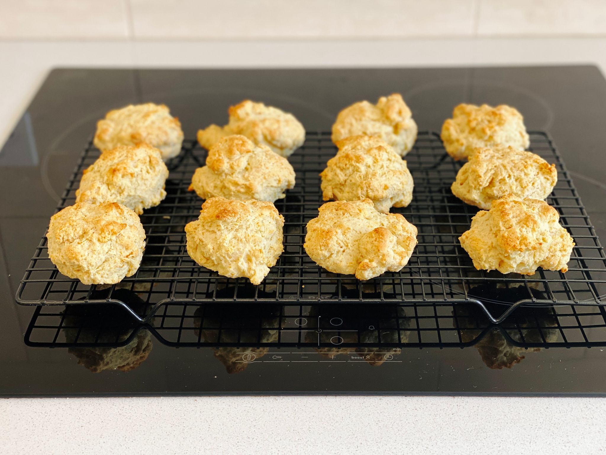 A photo of what look like essentially scones sitting on a cooling rack.