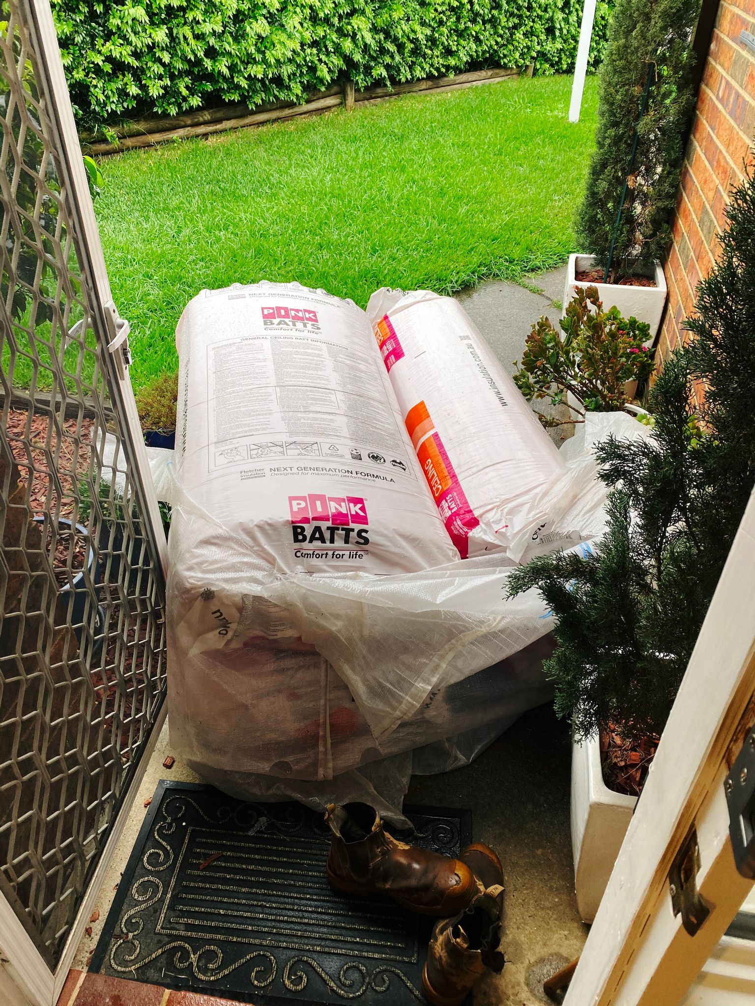 A photo of two large bags of "Pink Batts" ceiling insulation.