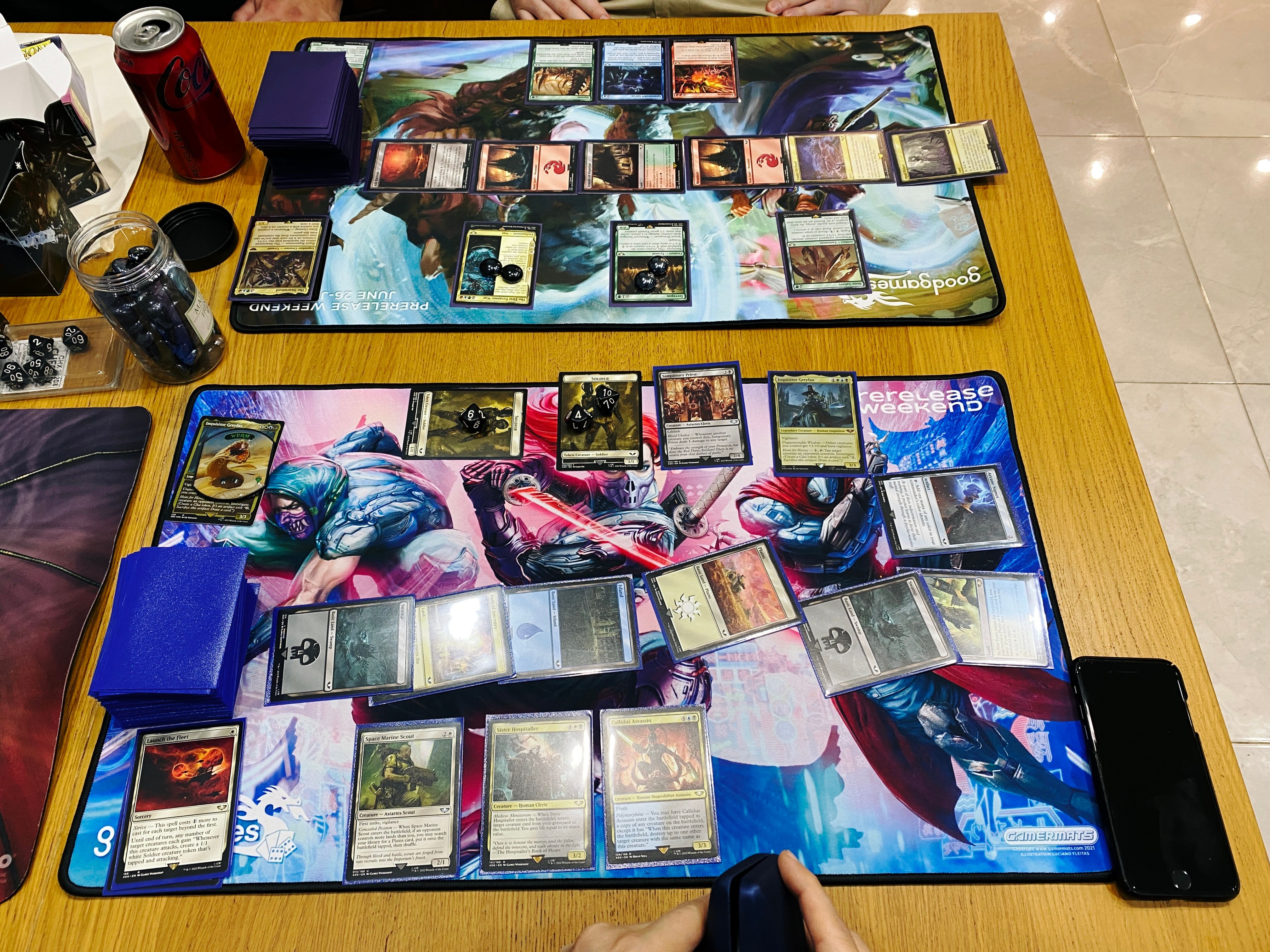A photo of a game of Magic: The Gathering at its final conclusion: me having attacked with 20 2/1 creature tokens (14 of which have Vigilance) and a 3/4 Lifelink and my 3/3 commander, and him with a single 2/2 creature.