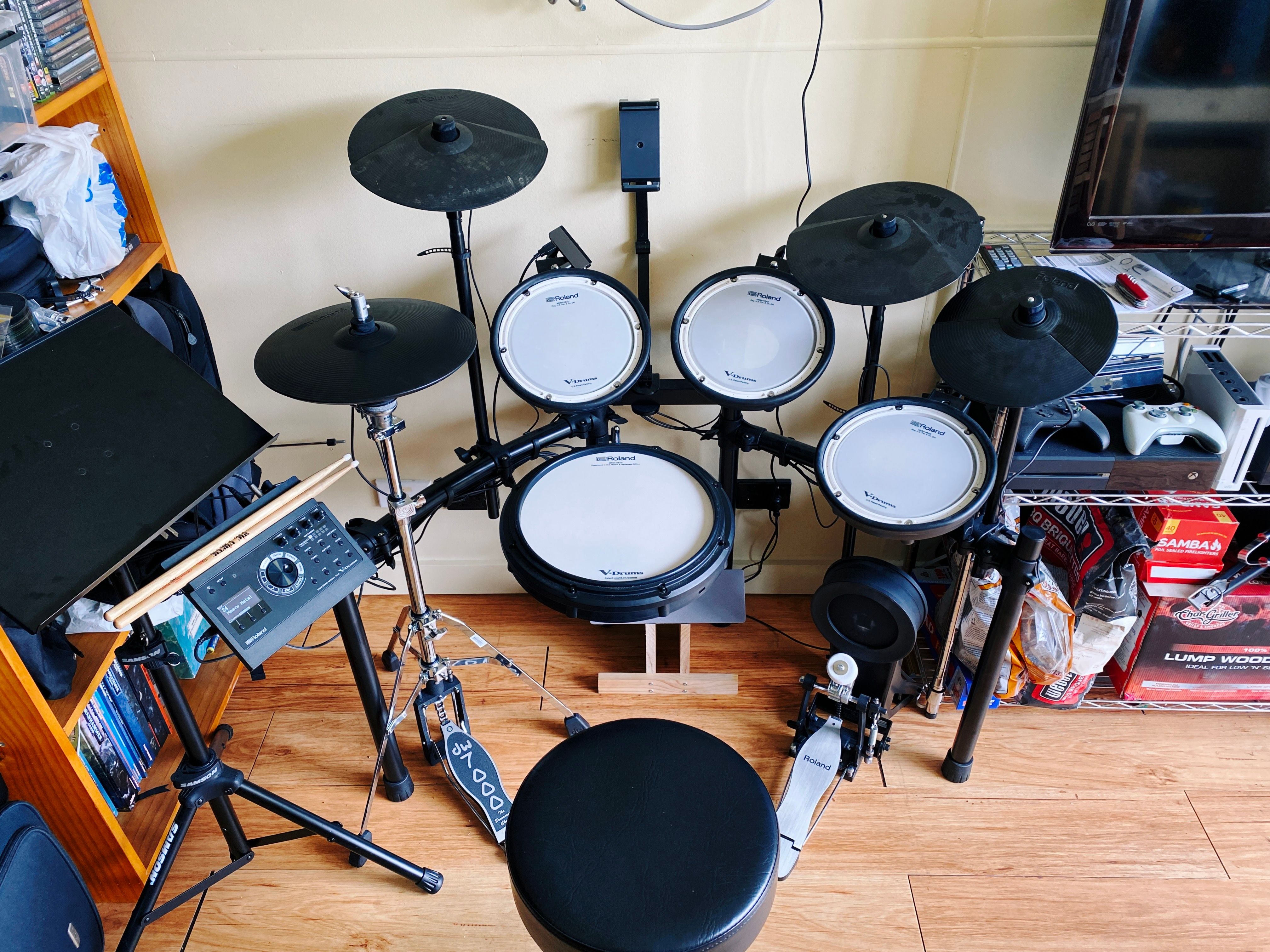 A photo of a Roland TV-17KV electronic drum kit that has a hi-hat mounted on an acoustic stand at the left, the standard crash and ride cymbals on the mid-left and mid-right respectively, and then the old hi-hat cymbal has been repurposed at the far right of the kit as a second crash cymbal.