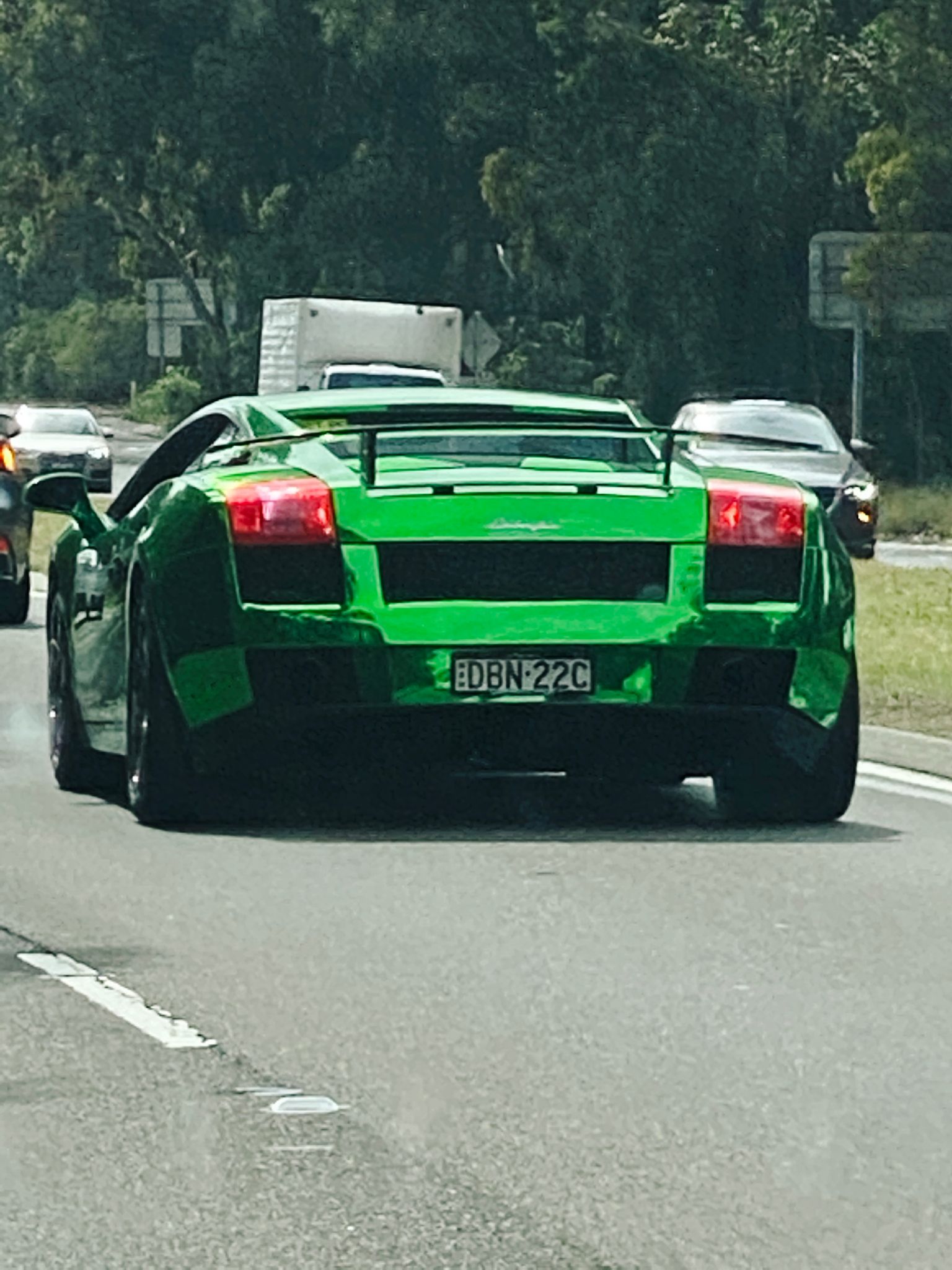 A photo of the rear of an EXTREMELY tacky-looking green shiny chromed Lamborghini.