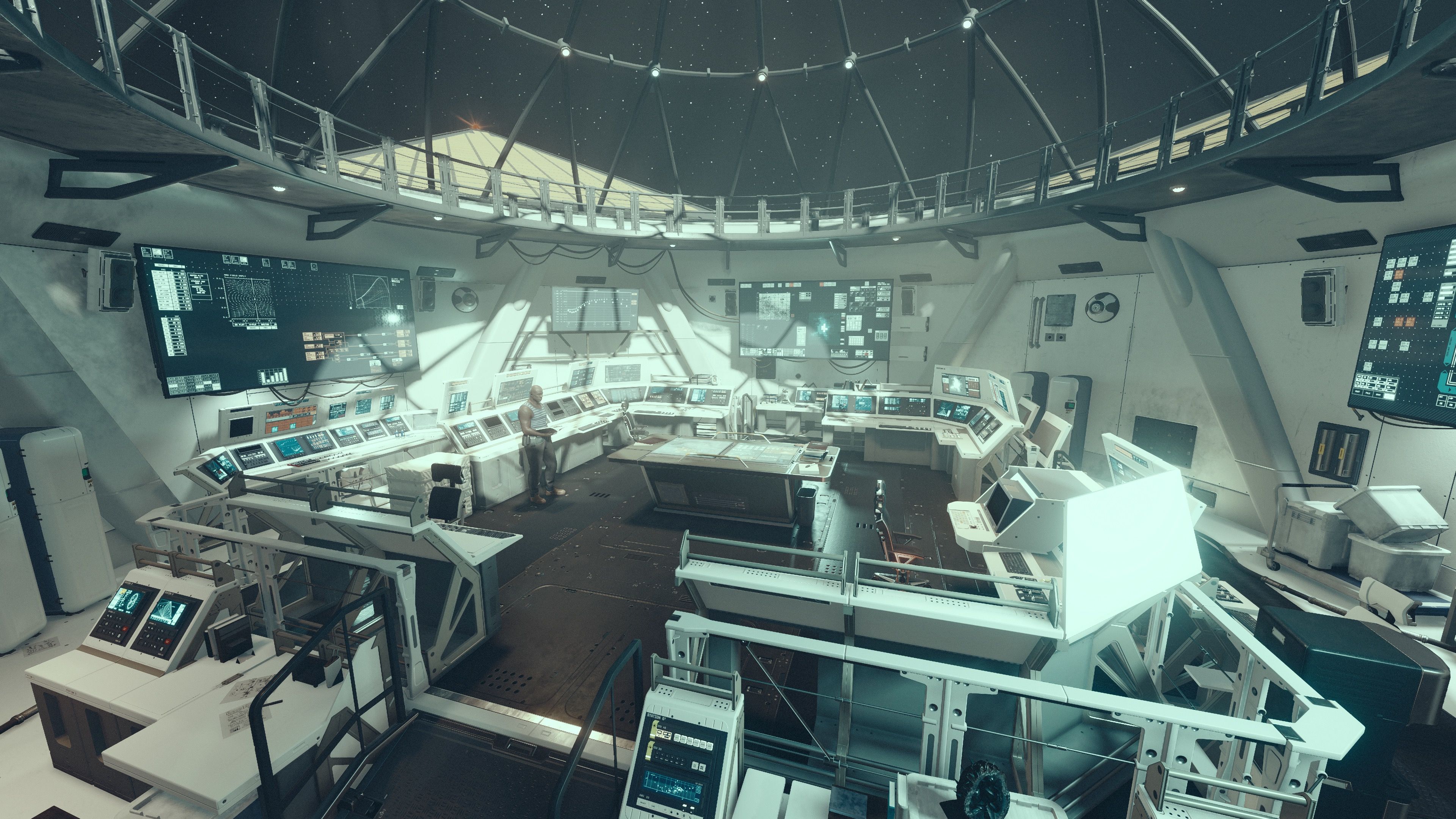 Another screenshot, this one is inside the main control room of the space station "The Eye" that's orbiting Jemison. The room is round and stark white, with rows of "NASA punk"-looking consoles with displays and buttons on them. The roof is clear glass looking out into space where you can see the stars.