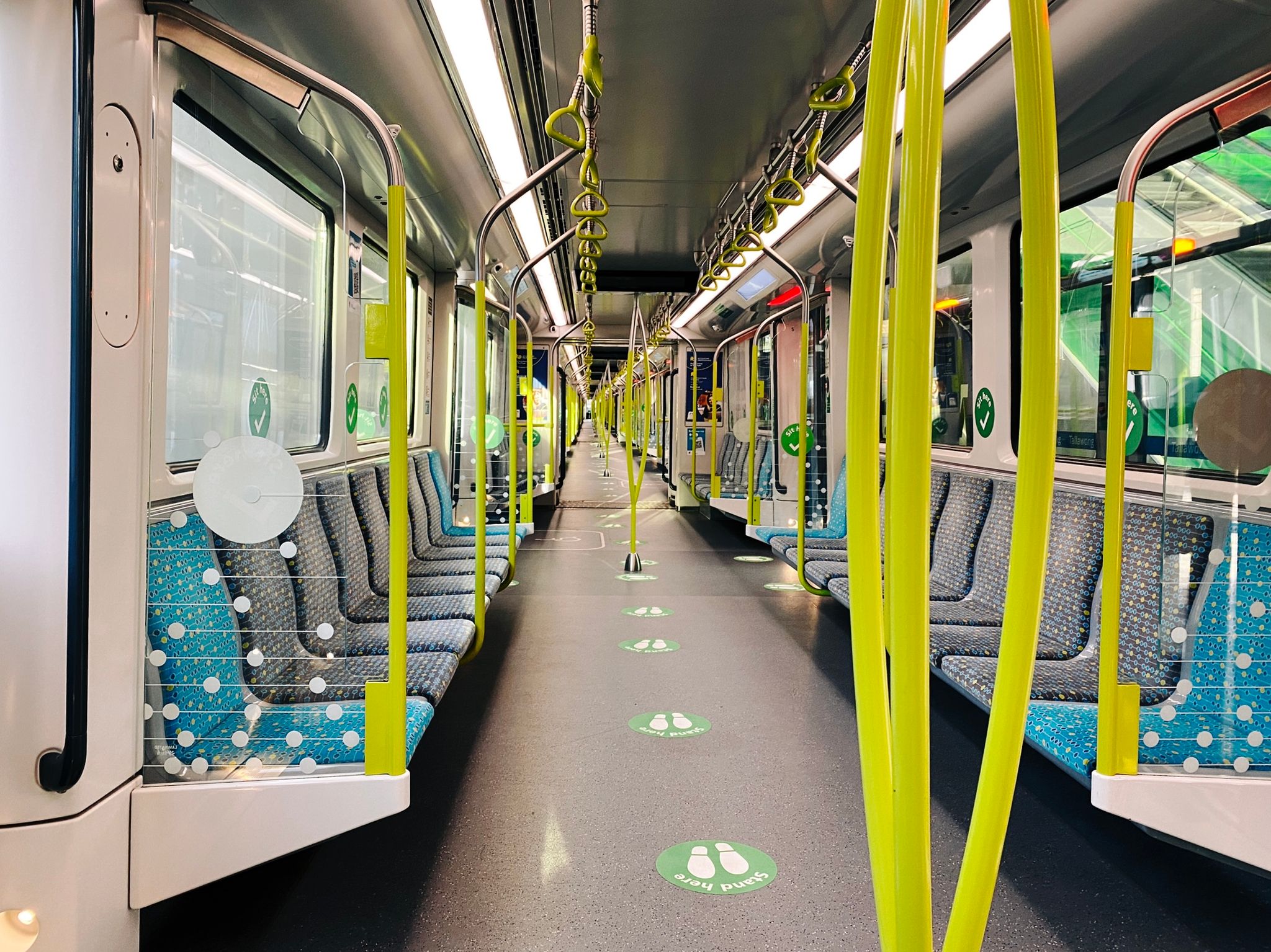 A photo looking down the entire length of a Sydney Metro train, with absolutely nobody on it.