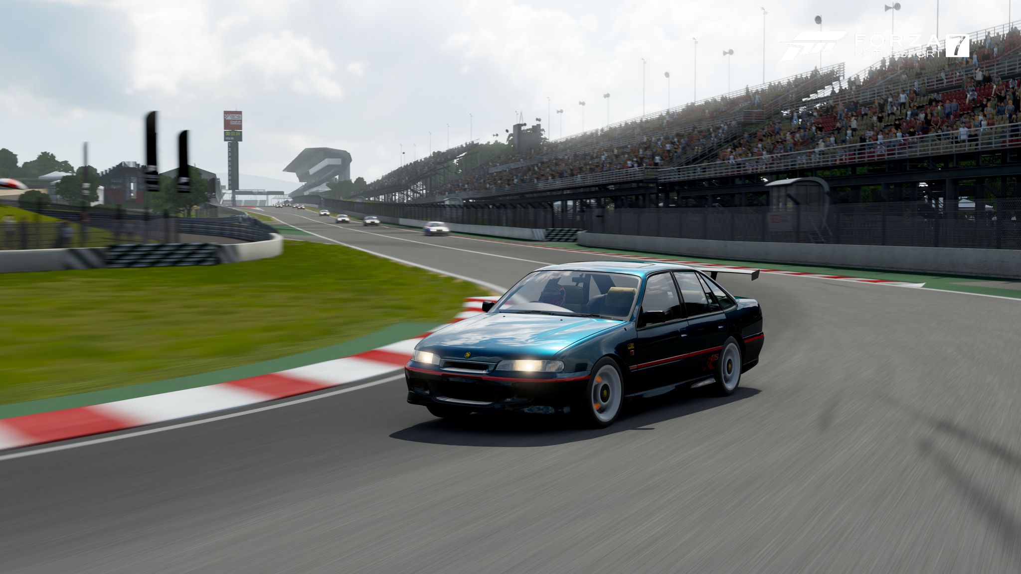 A screenshot from Forza Motorsport 7 on the Xbox One showing a 1996 Holden HSV GTSR going around a corner mid-race.
