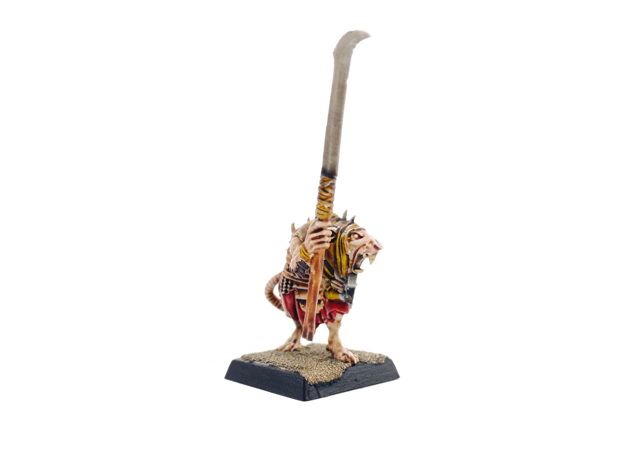 A photo of a rank-and-file Skaven from the old 8th Edition Warhammer box. It's small hunched-over but humanoid rat creature with a leather head/shoulder covering, red cloth underneath copper-coloured armor, and brandishing a very tall not-quite-scythe.