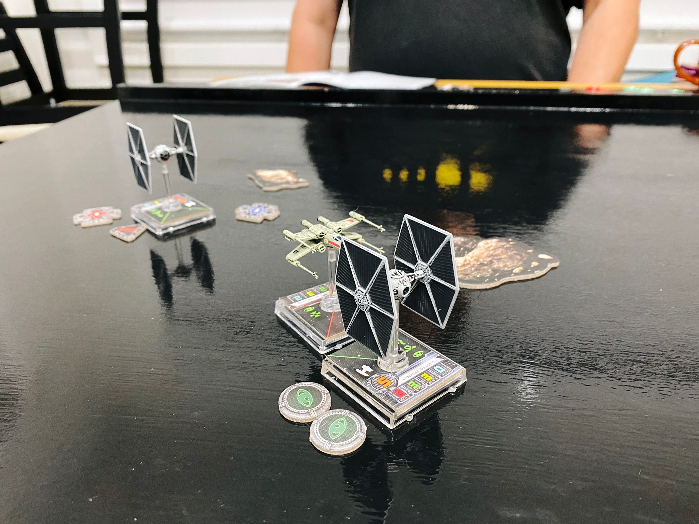A photo of the X-wing and the TIE Fighter directly facing each other, with literally a few millimetres separating their bases.