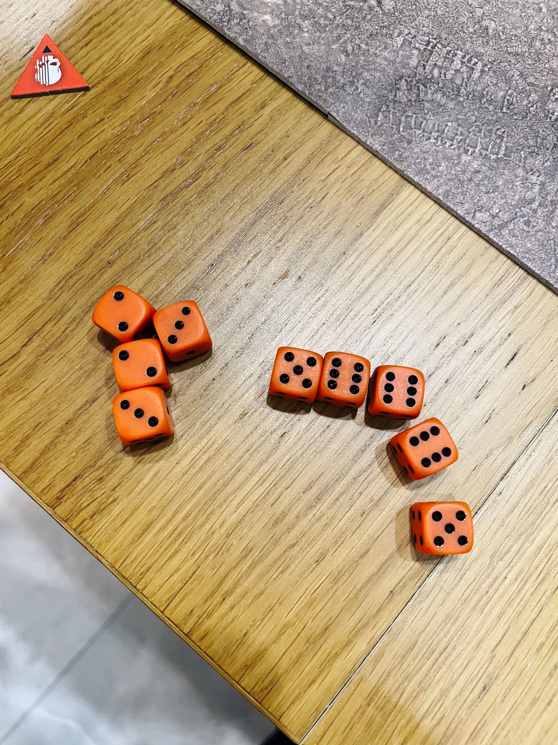 A photo of nine six-sided dice, three of them are sixes, two are fives, and there's two twos and two threes.