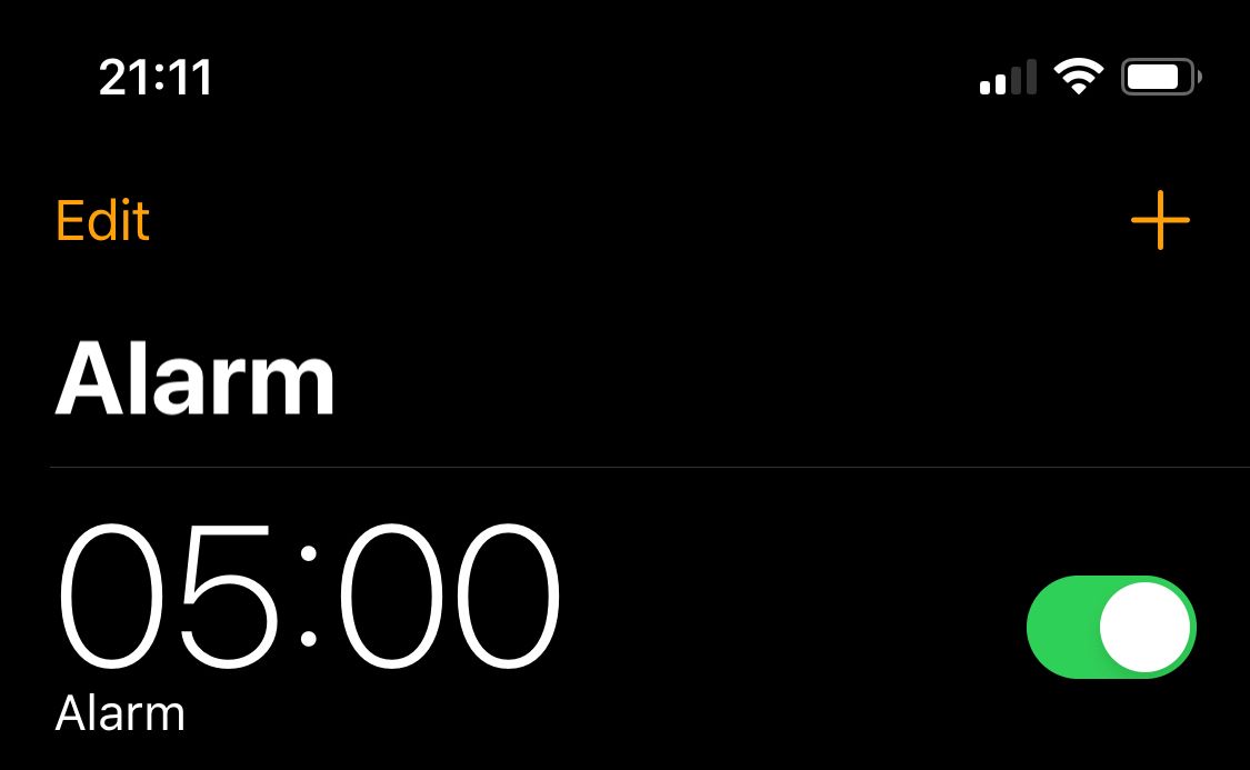 A screenshot of the iOS Alarms app with a 5:00am alarm set.
