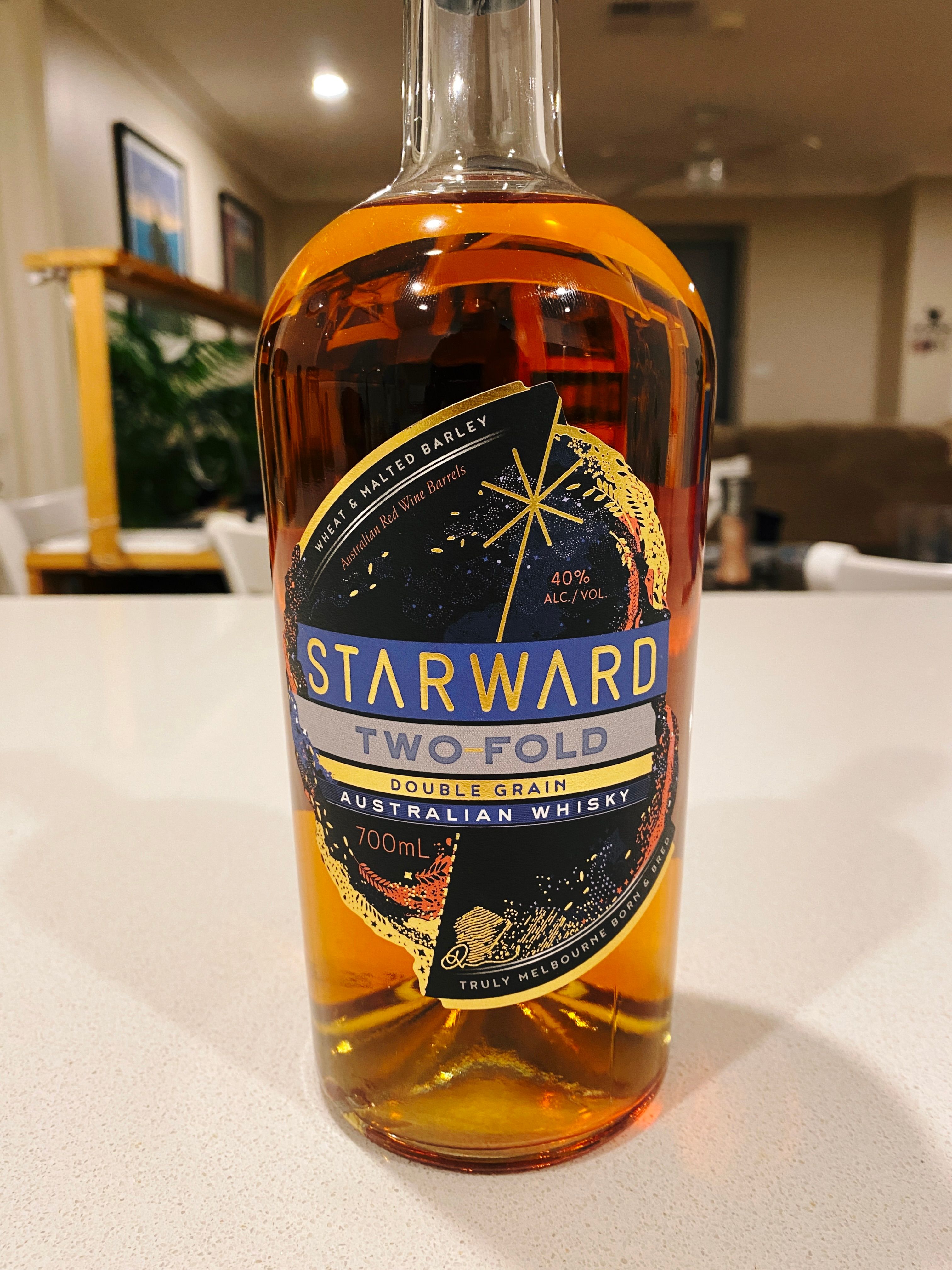 A photo of a bottle of Starward brand "Two Fold" Australian whisky. The label is all handsome blue and gold.
